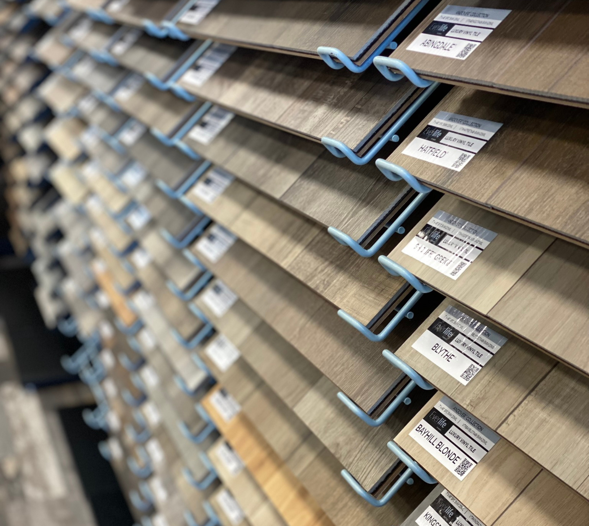 Women holding flooring sample in floor store 