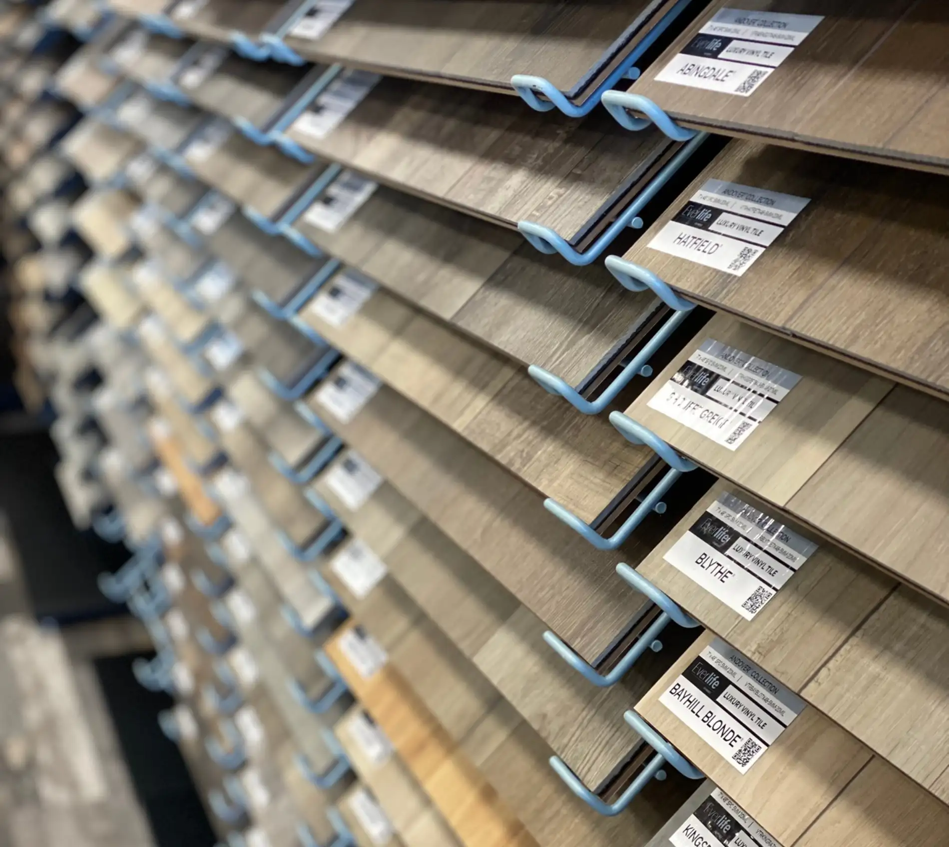 Women holding flooring sample in floor store 