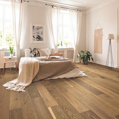 warm light tones hardwood floors in a bright neutral toned bedroom